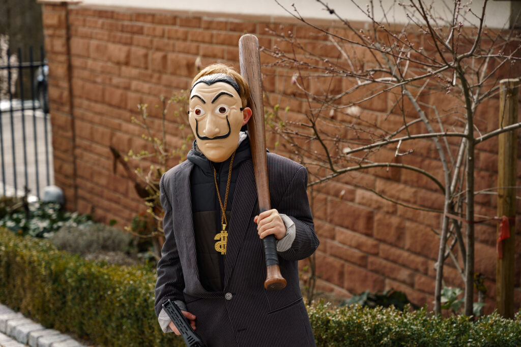Participant dressed up in costume and mask holding a baseball bat